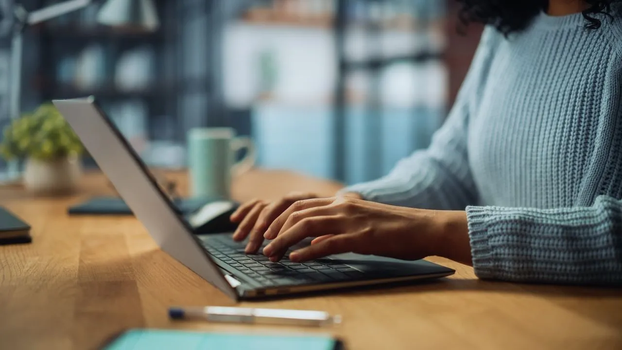 Background photo of woman typing on laptop